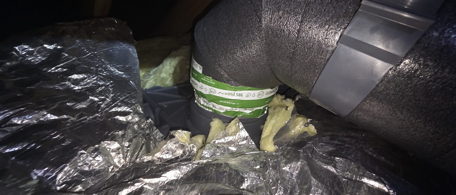 Duct joint sealed with tape and secured in the attic