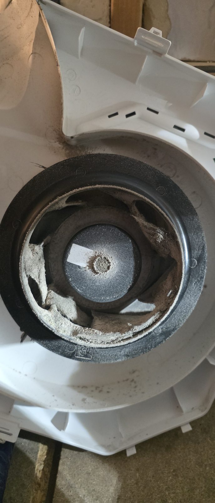 Dust built up in the fan housing of an MEV unit