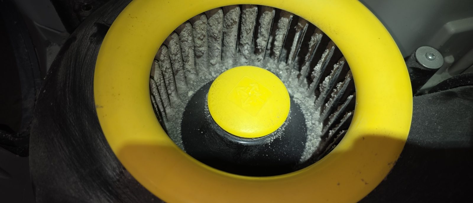 Dust on the blades of an MVHR fan with a yellow hub