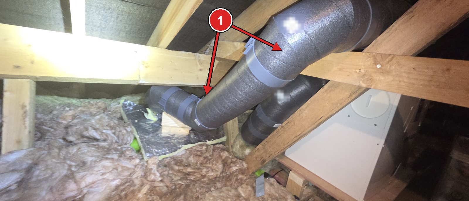 Shop-bought pre-insulated MVHR ducts in an attic, resting on timber blocks