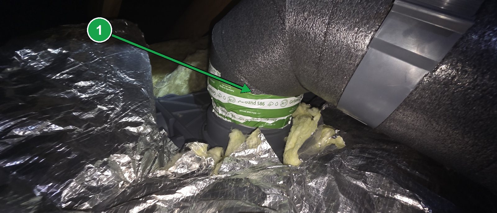 The same duct joint pushed back together and secured with strong tape