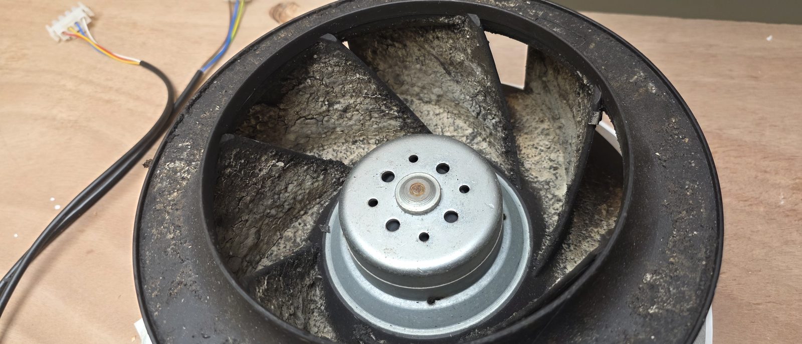 MVHR Servicing in Waterford & South Tipperary - Eco Vent Ireland Dust caked on the blades of a worn ventilation fan